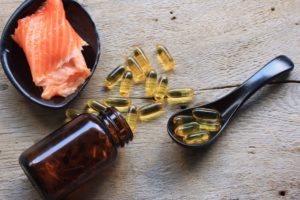 Salmon next to omega-3 supplements