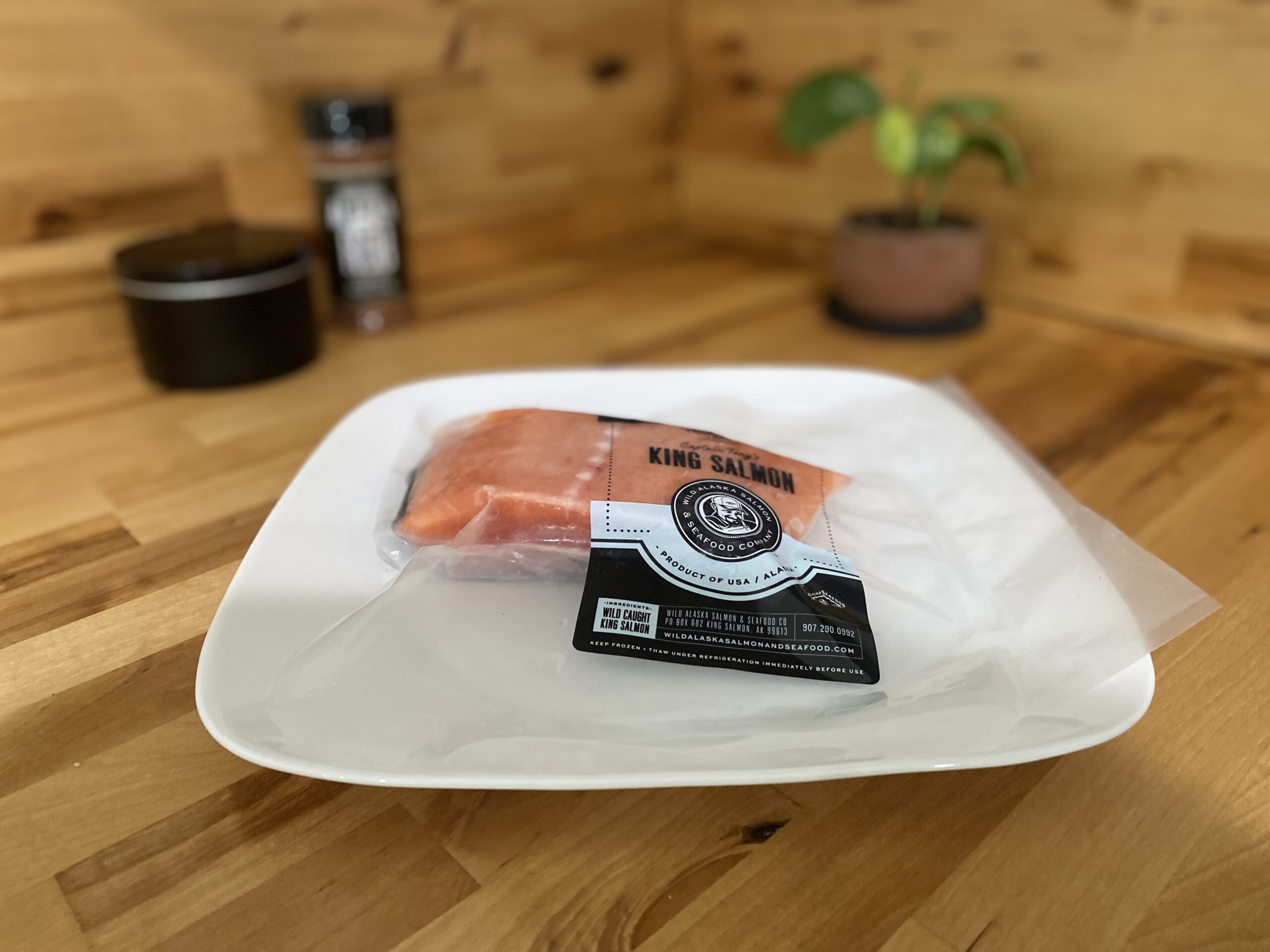 Wild Caught King Salmon portion frozen in package thawing on counter