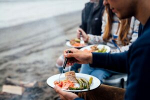 People eating a salmon dinner